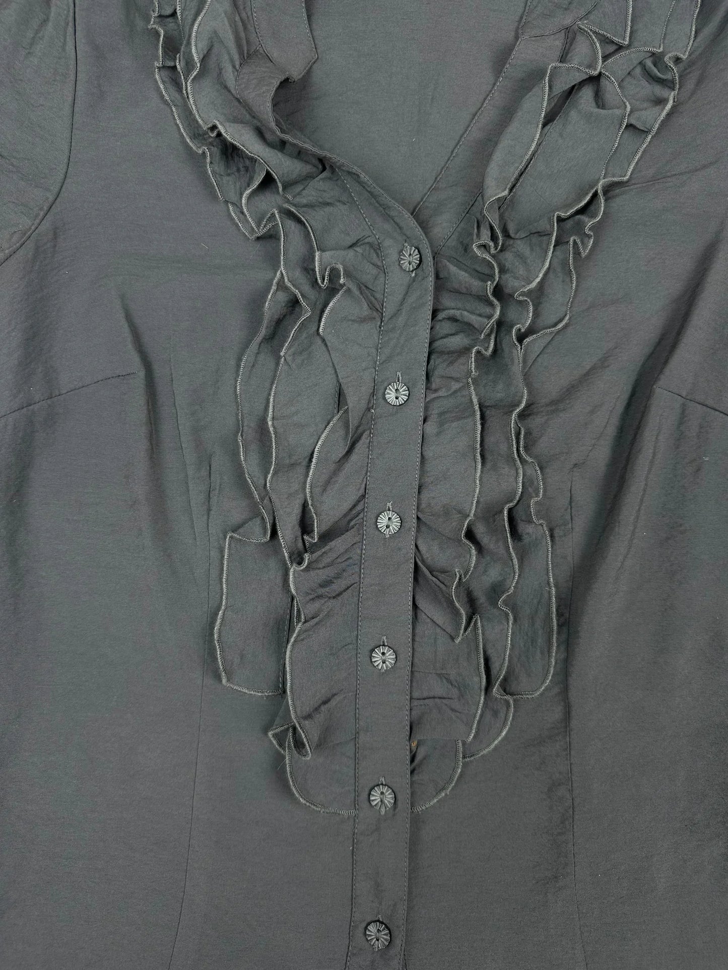 Detail view of a short sleeve shirt in dark gray with ruffled front.