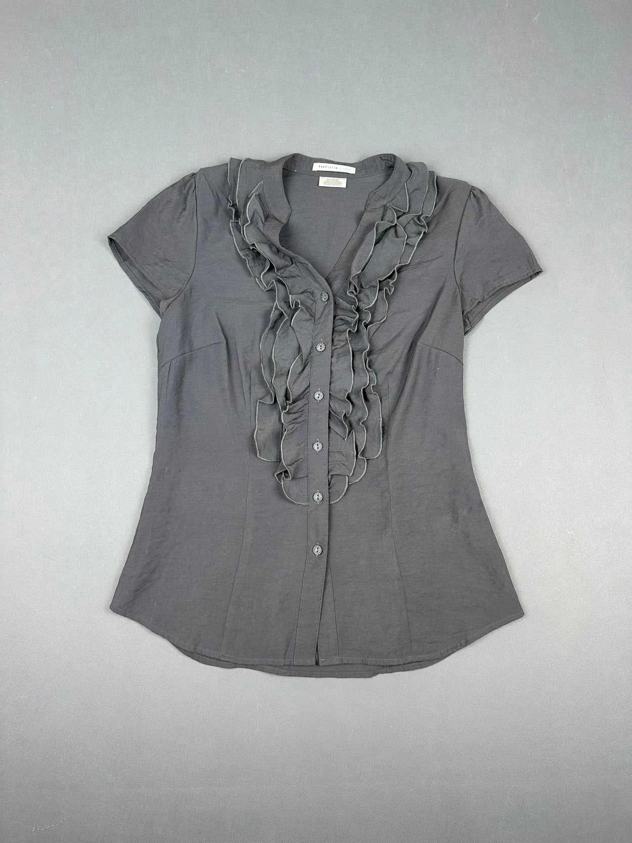 Front view of a dark gray short sleeve shirt with ruffled detail.