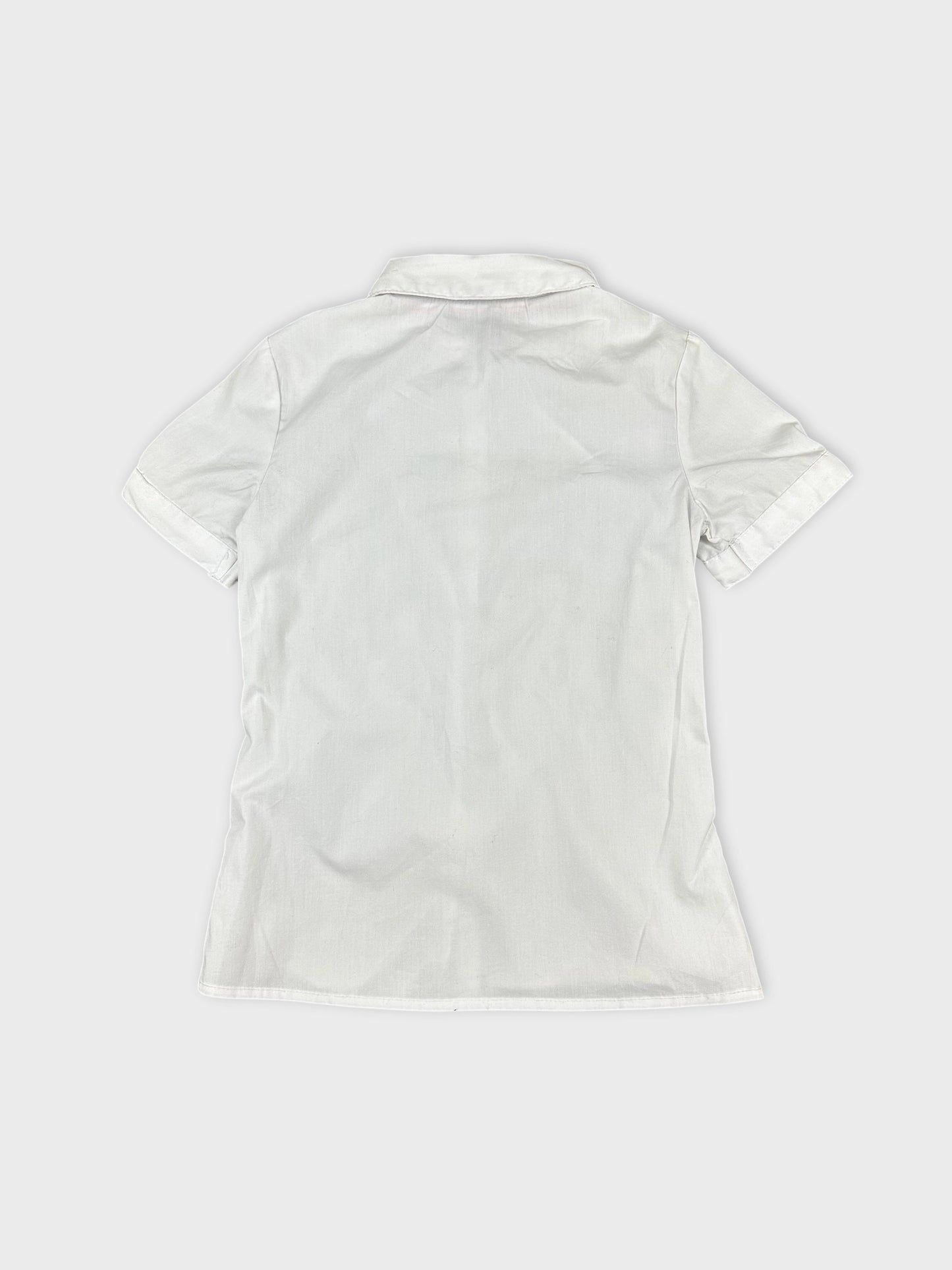 Back view of women's short sleeve white shirt with folded sleeves.