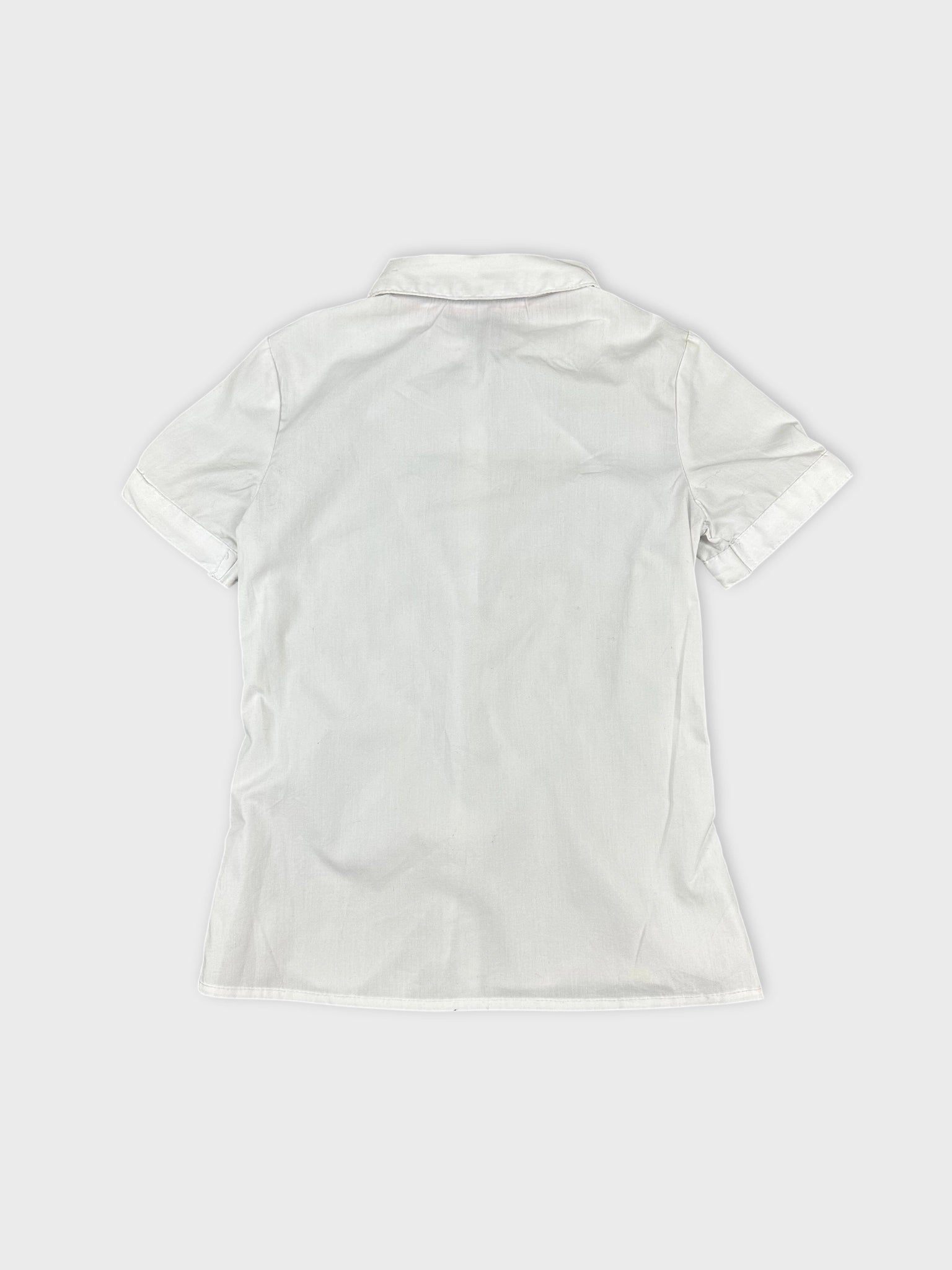 Back view of women's short sleeve white shirt with folded sleeves.
