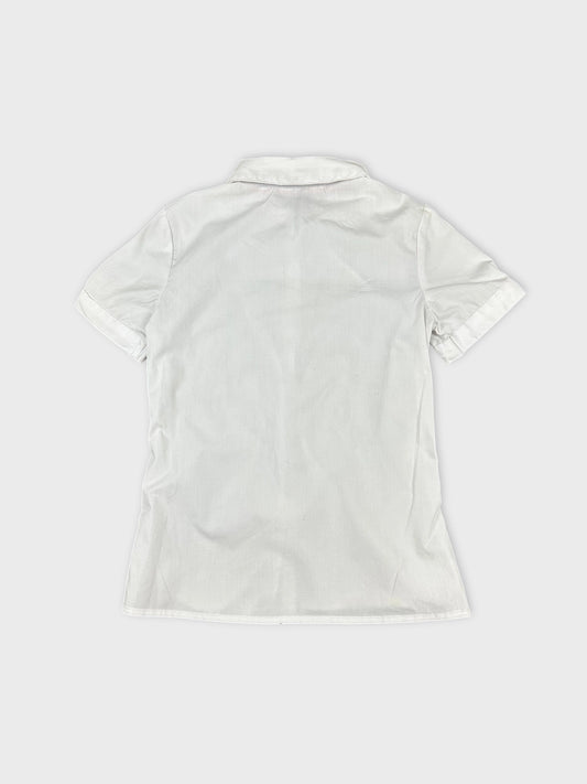 Back view of women's short sleeve white shirt with folded sleeves.