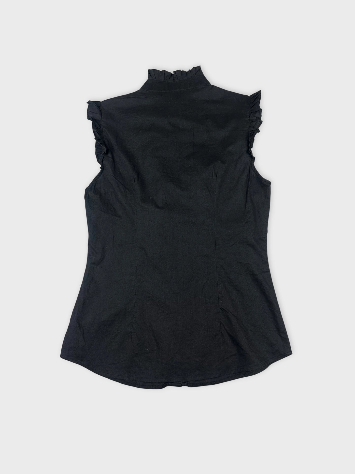 Back view of a black sleeveless shirt with ruffled trim.