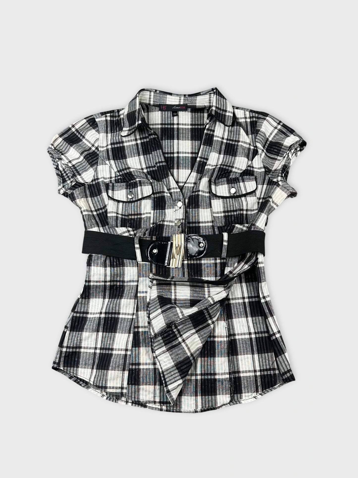 Detail view of a black and white plaid shirt with a wide belt