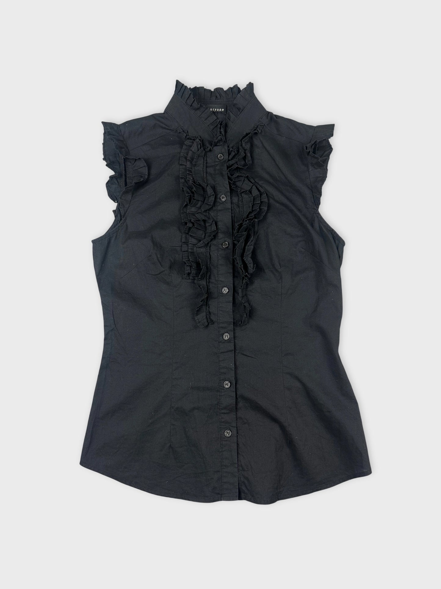 Front view of a black short sleeve shirt with ruffled detailing.