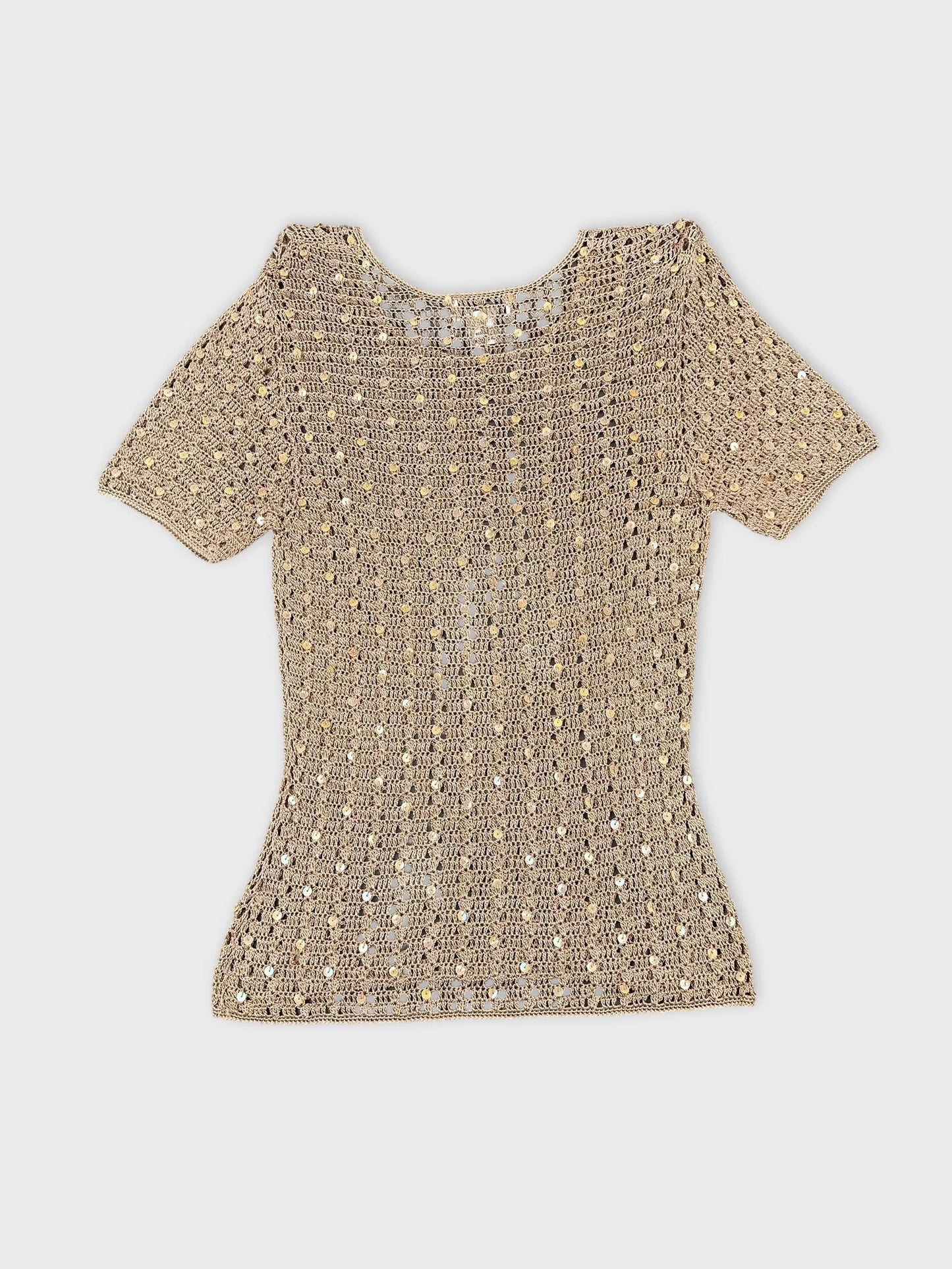 Back view of a gold short sleeve top with a crochet pattern.