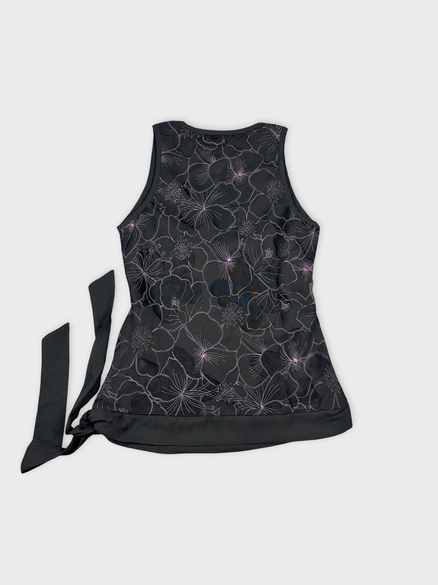 Back view of a black sleeveless top featuring floral patterns.