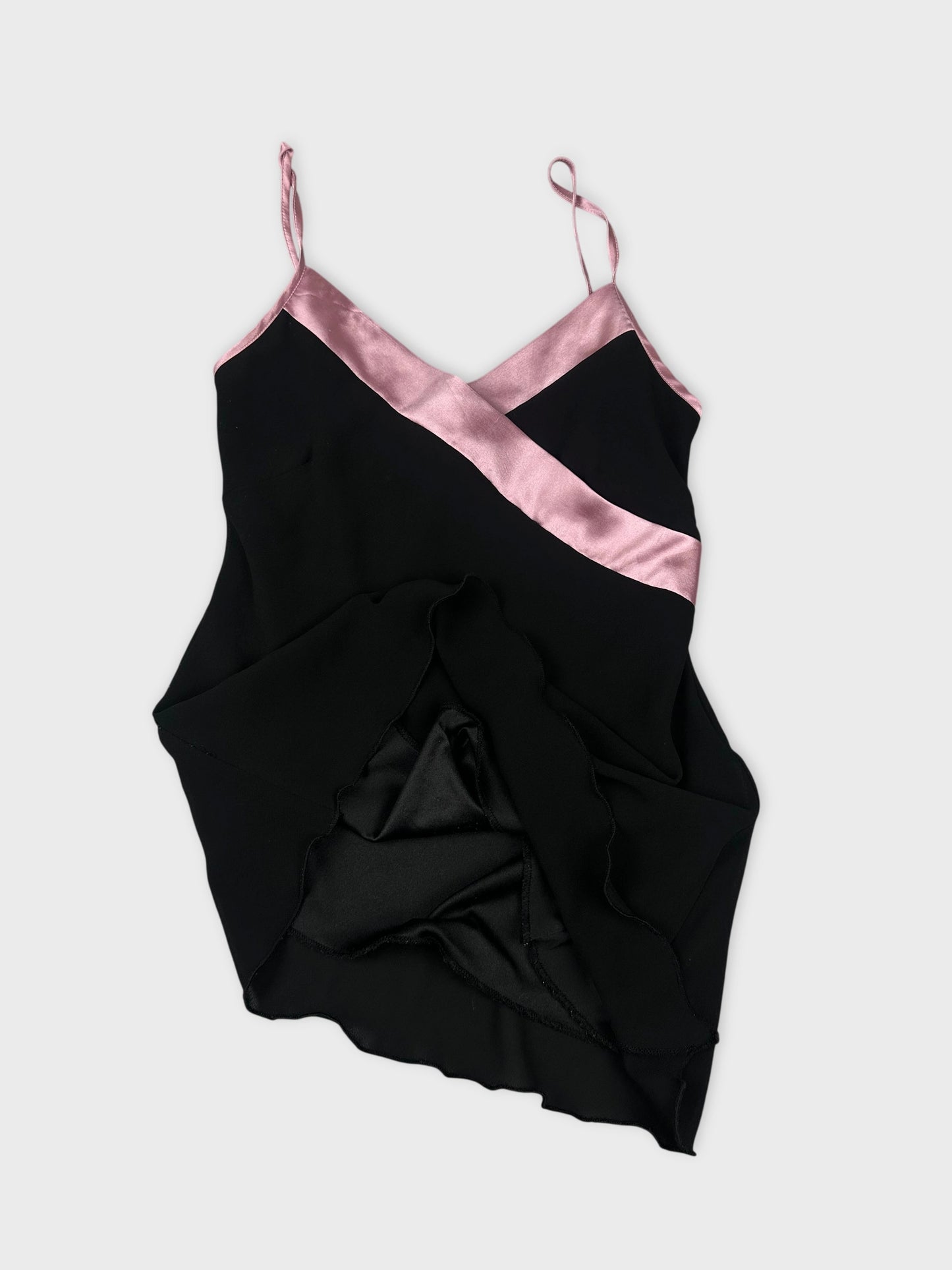 Detail view of a black camisole top with pink satin trim.
