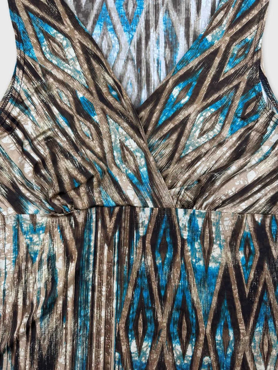 detail view of a vintage women's top in blue and brown zigzag pattern