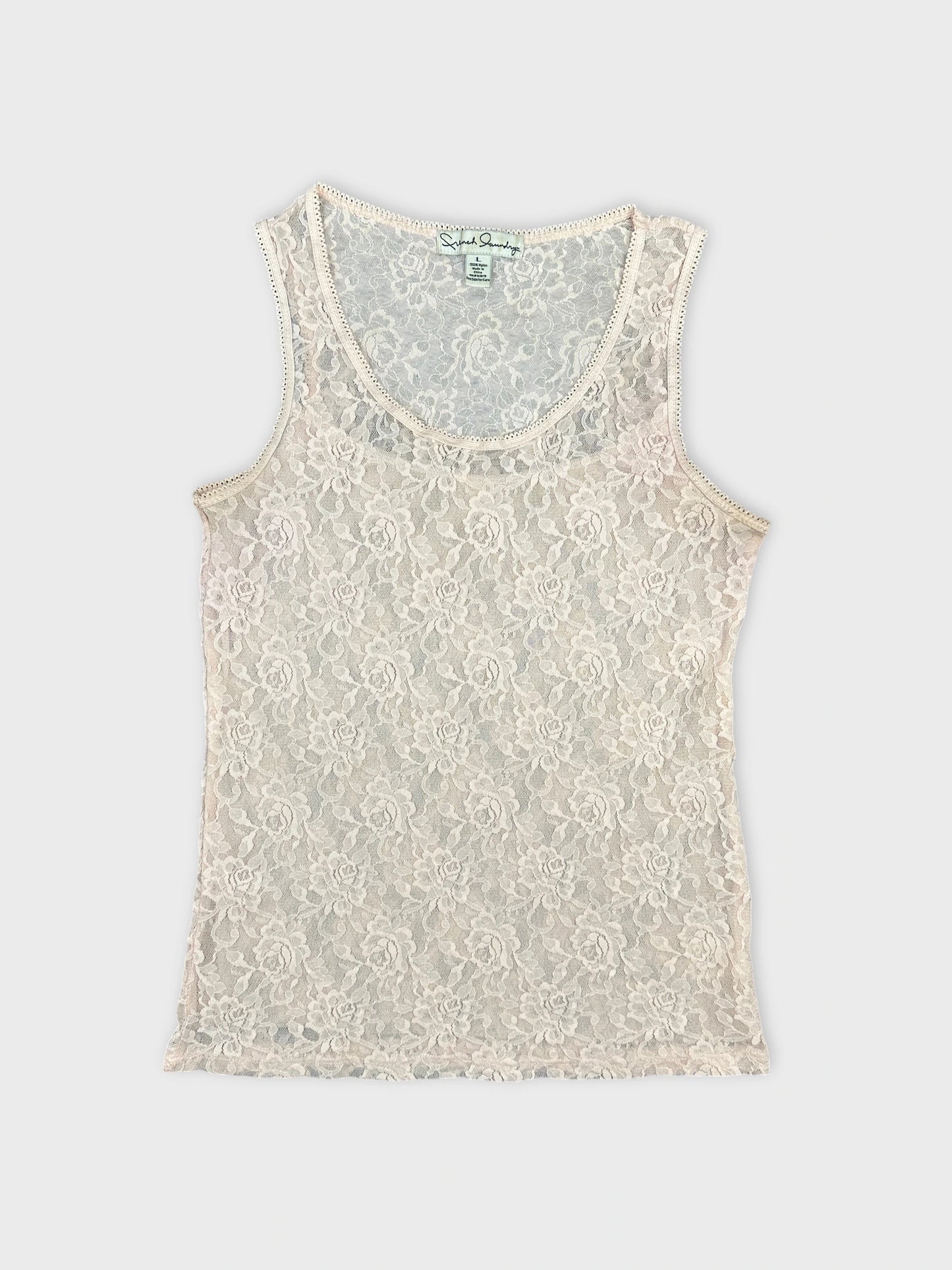 Front view of a lace women's top in pale pink with floral pattern.