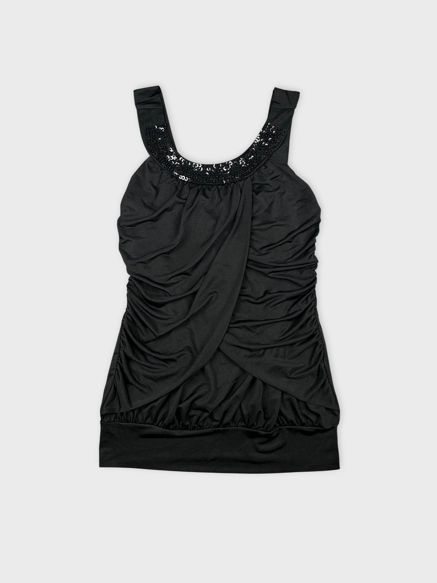 Front view of a black sleeveless top with a ruched design and sequin detail.
