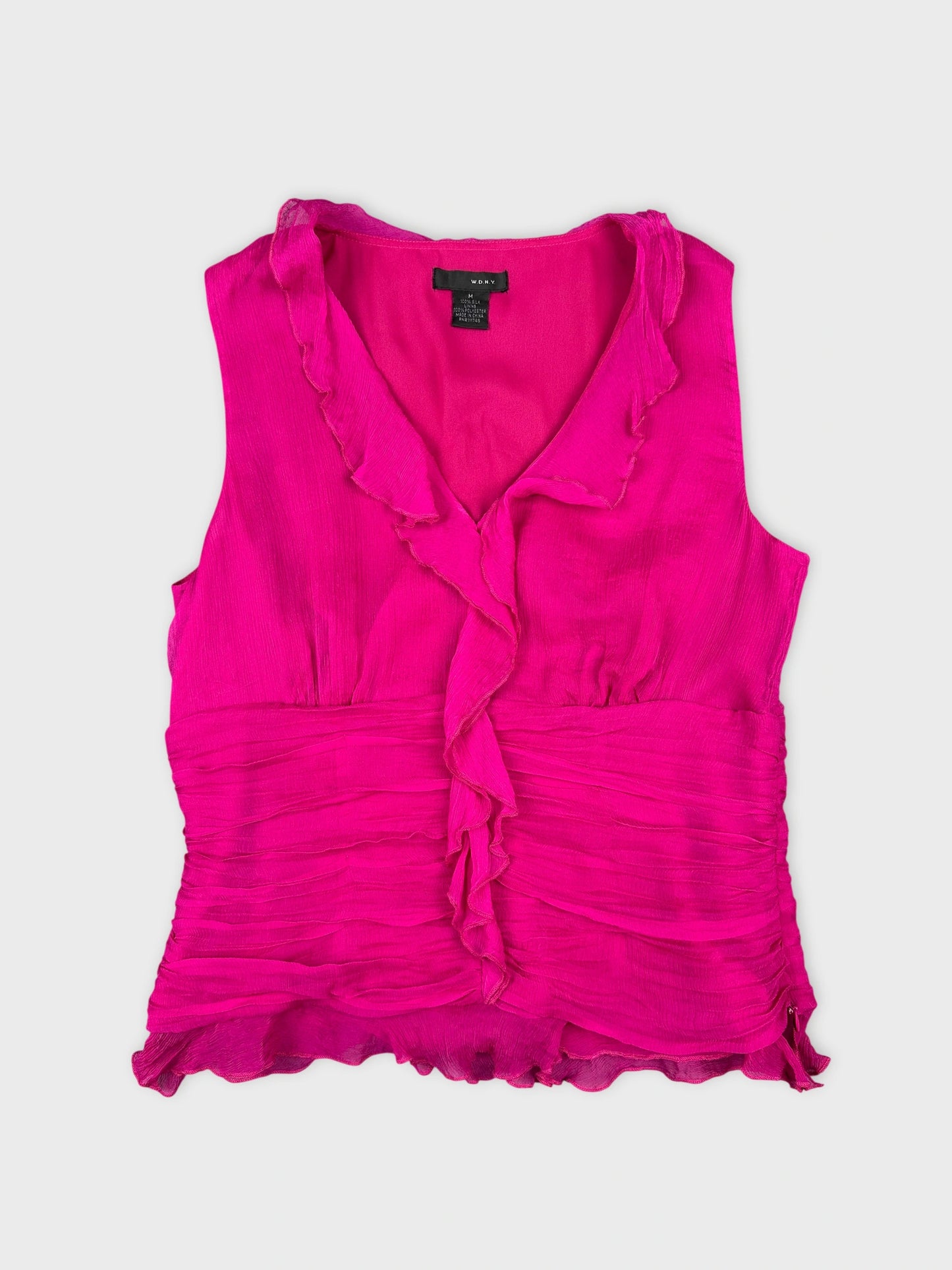 Front view of a vibrant pink sleeveless top with ruffled trim.