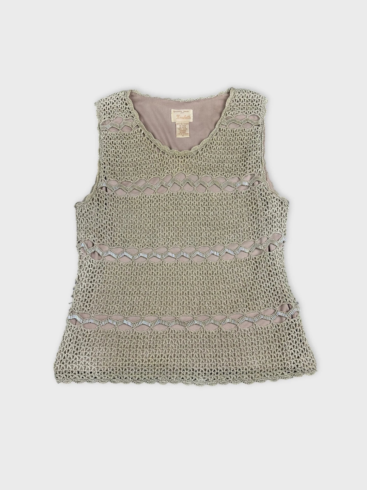 Front view of a vintage short sleeve top in light green with a crochet pattern.