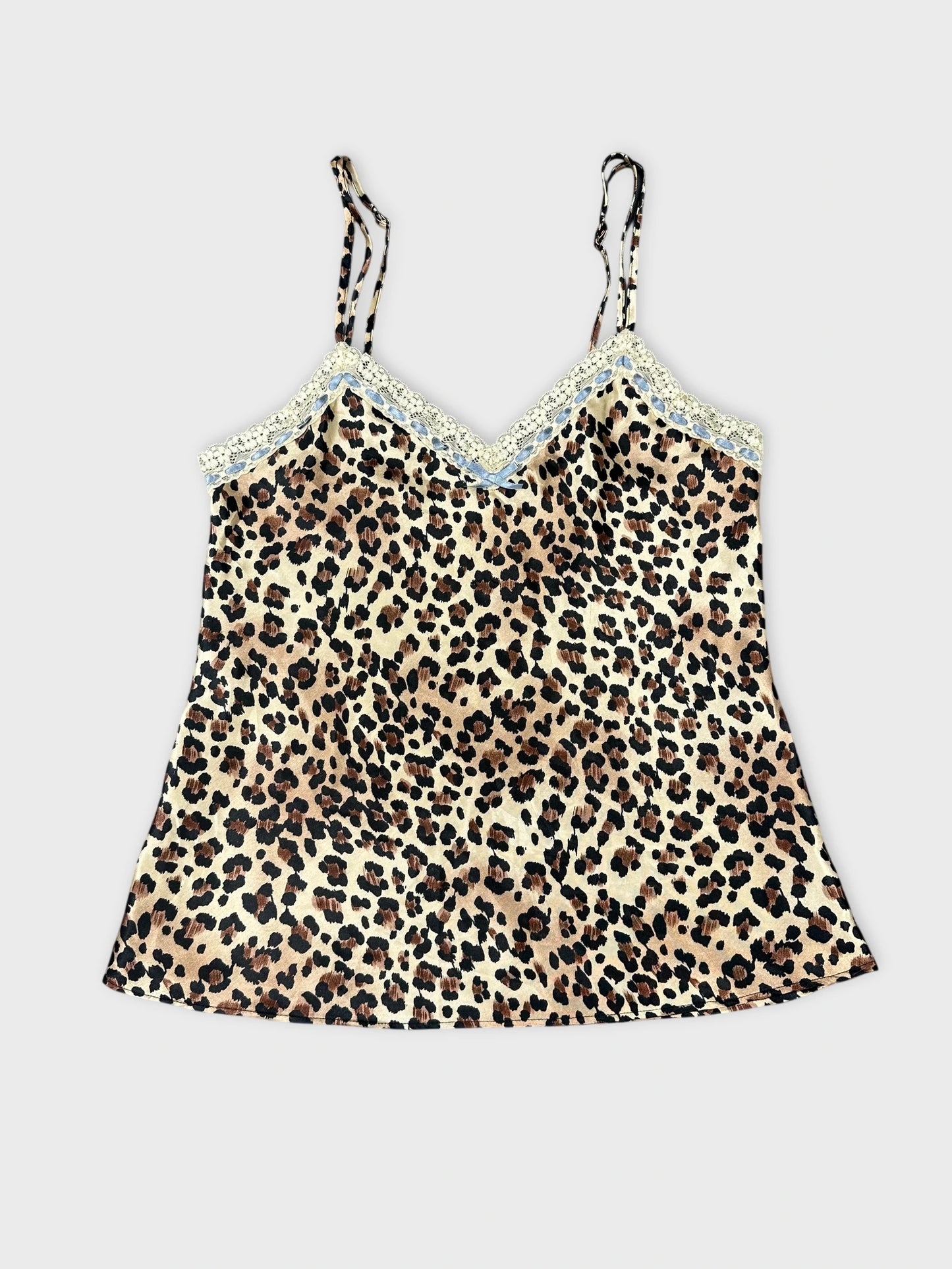 Front view of a women's leopard print top with lace trim.