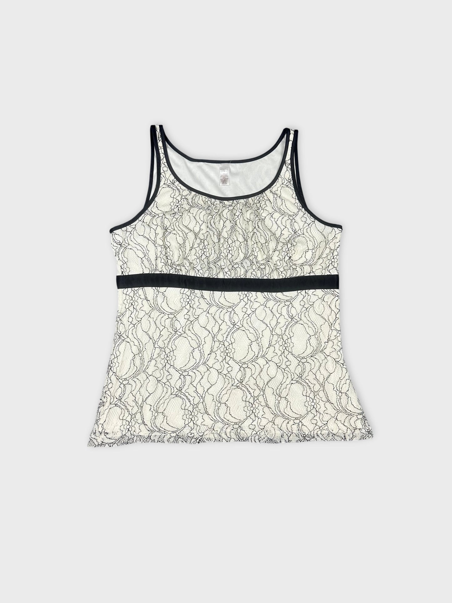 Front view of a cream lace top with black trim detailing.
