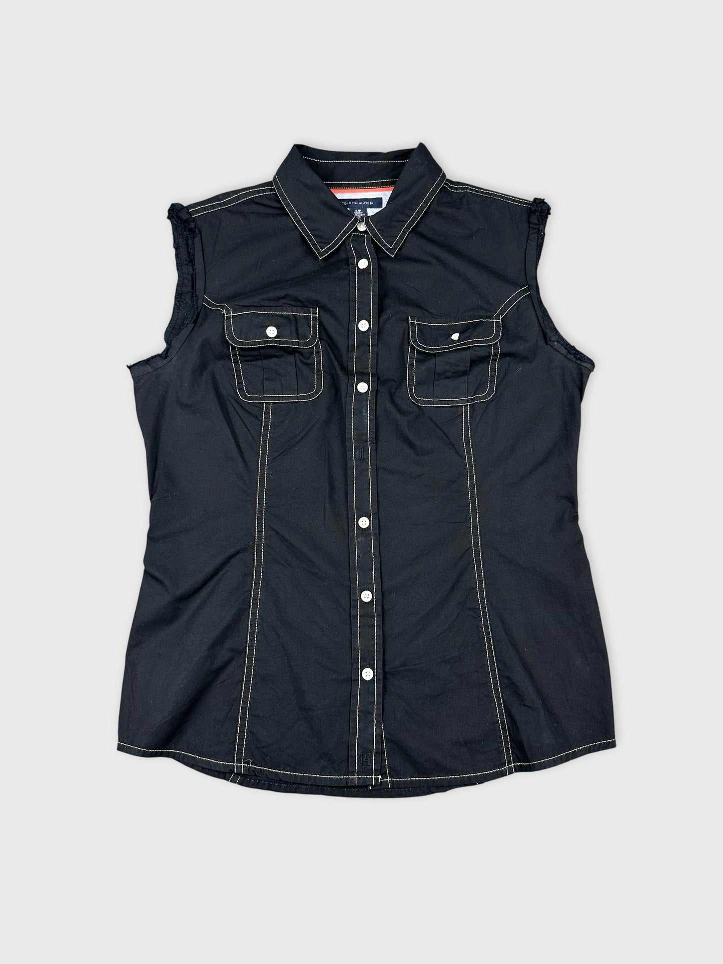 Front view of a black sleeveless top featuring chest pockets and contrast stitching.