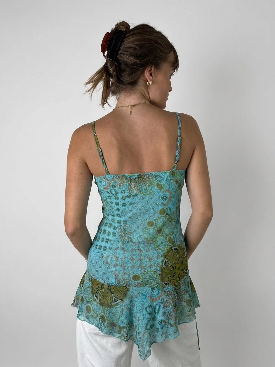 Back view of a turquoise women's sleeveless top with a floral pattern.