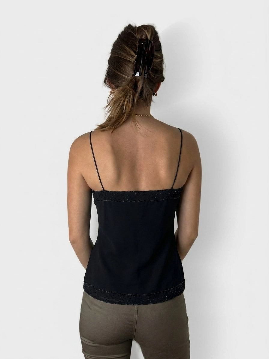 Back view of a black women's sleeveless top with lace trim.