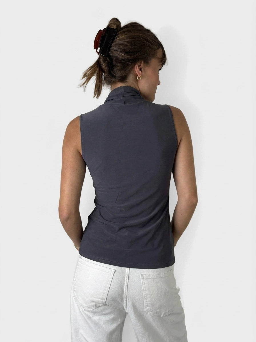 Back view of a dark gray sleeveless top with a high neckline.