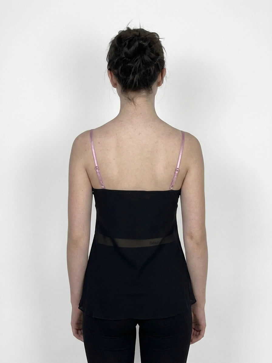Back view of a black women’s top featuring sheer detailing.