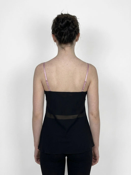 Back view of a black women’s top featuring sheer detailing.
