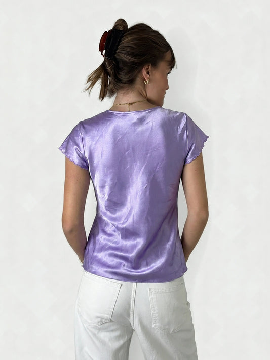 Back view of a purple short sleeve top with ruffled trim.