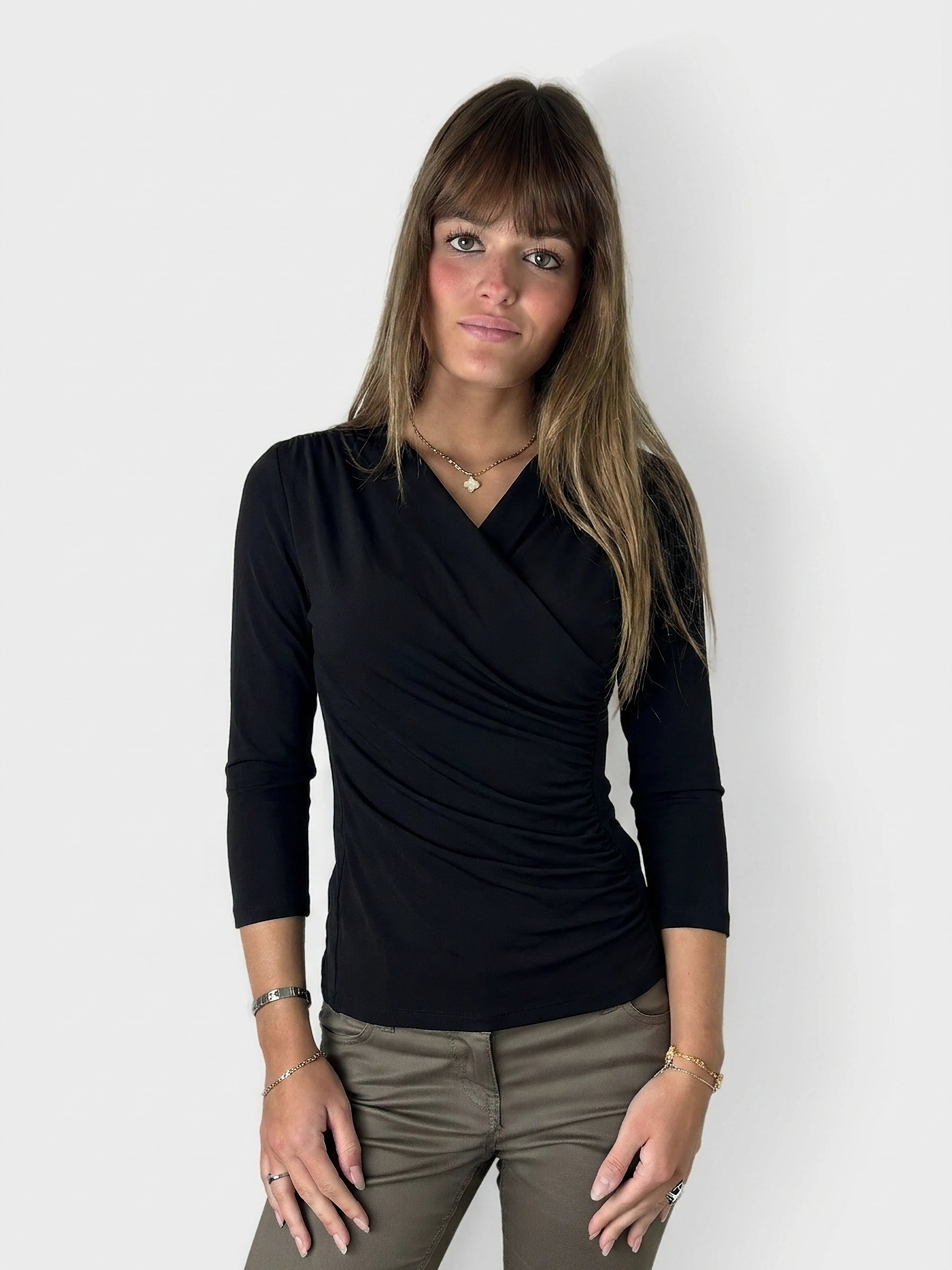 Black long-sleeve top with side ruching, shown in front view.