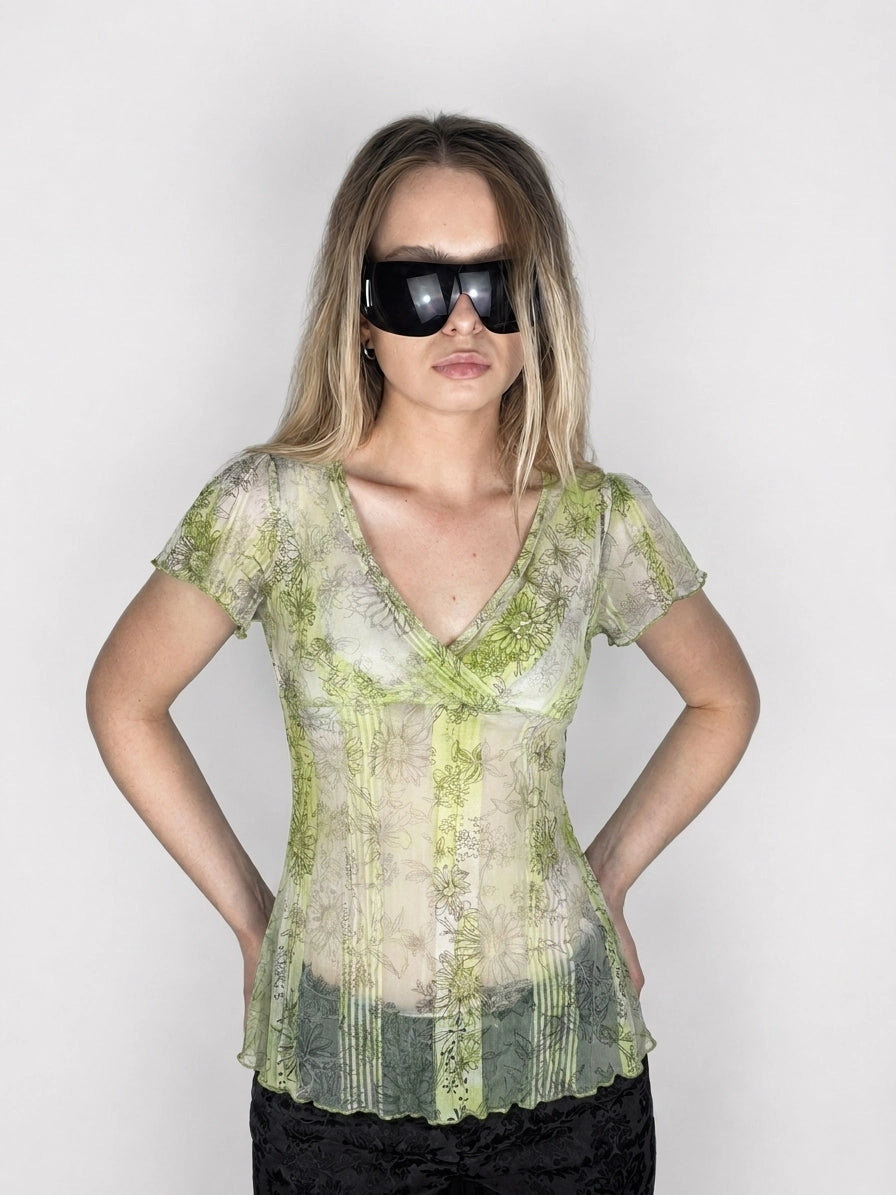Front view of a vintage short sleeve top in green with floral print.