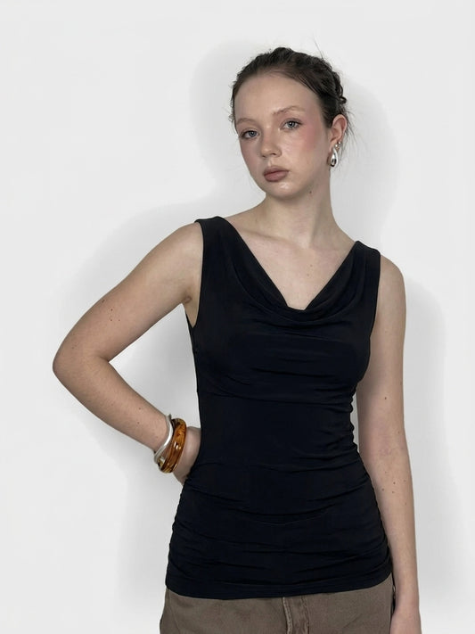 Front view of a black sleeveless top with a draped neckline.