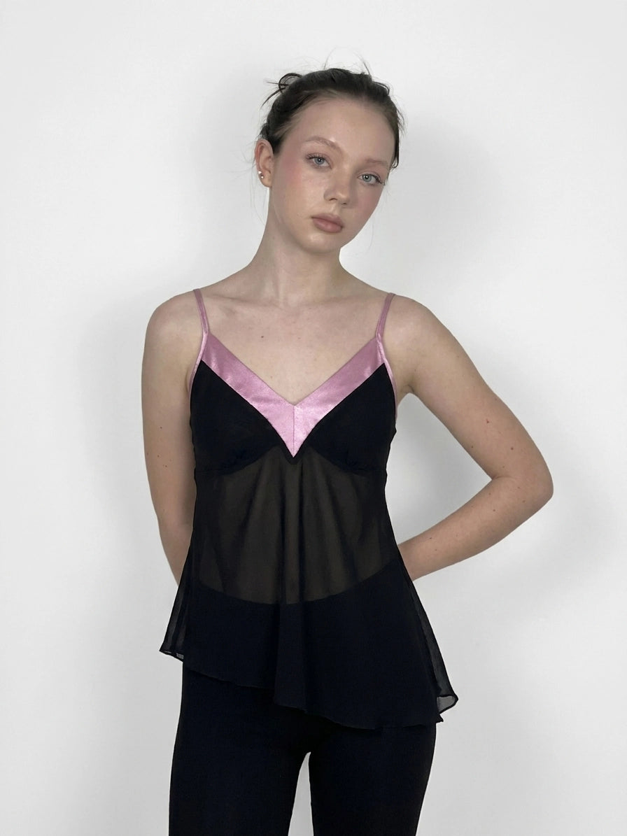 Black vintage top with pink trim, front view, featuring a flared hemline.