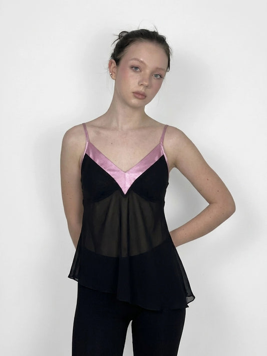 Black vintage top with pink trim, front view, featuring a flared hemline.