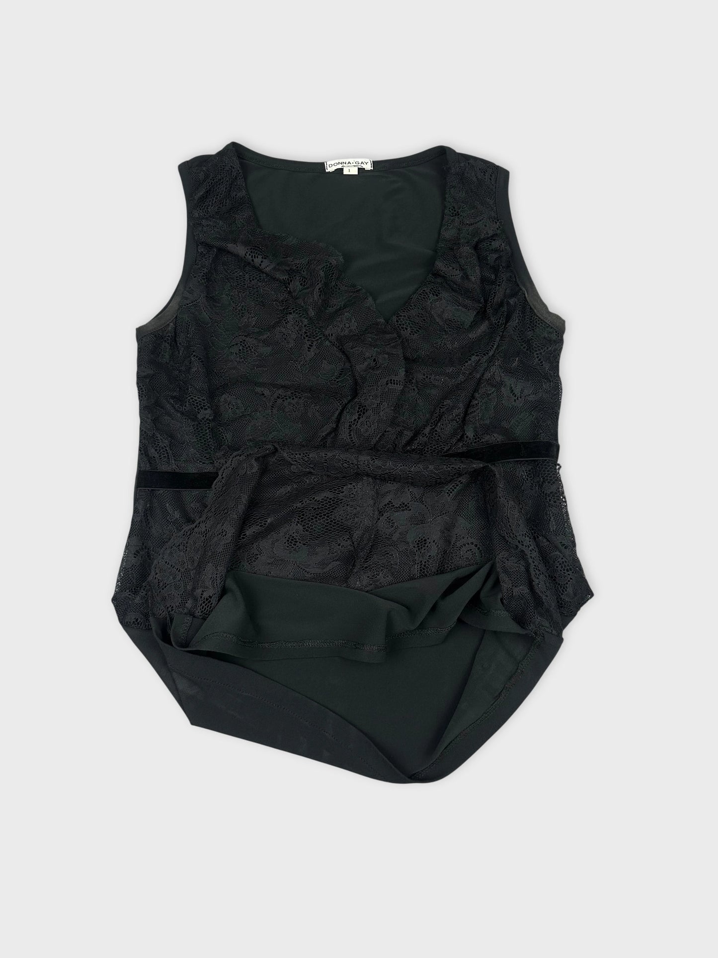 Detail view of a black vintage women’s top featuring lace trim.