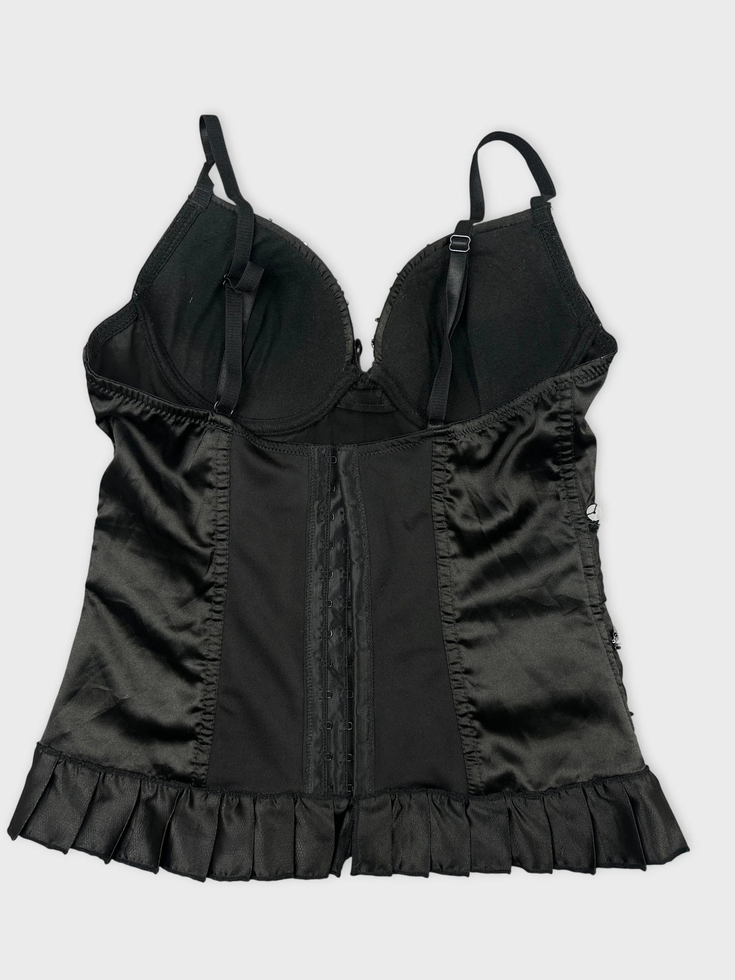 Back view of a black vintage blouse with ruffle trim.