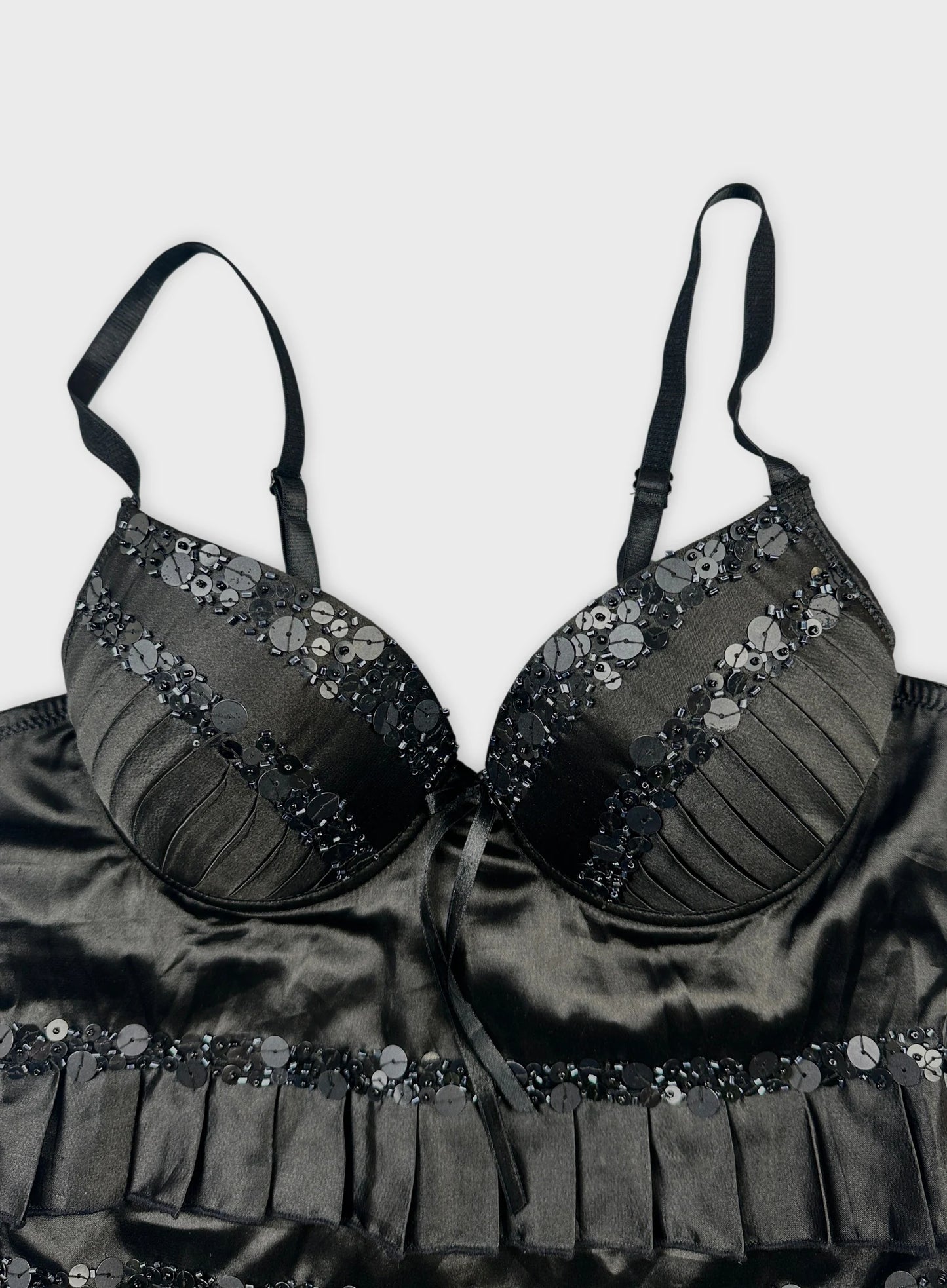 Detail view of a black vintage bra with sequin embellishments.