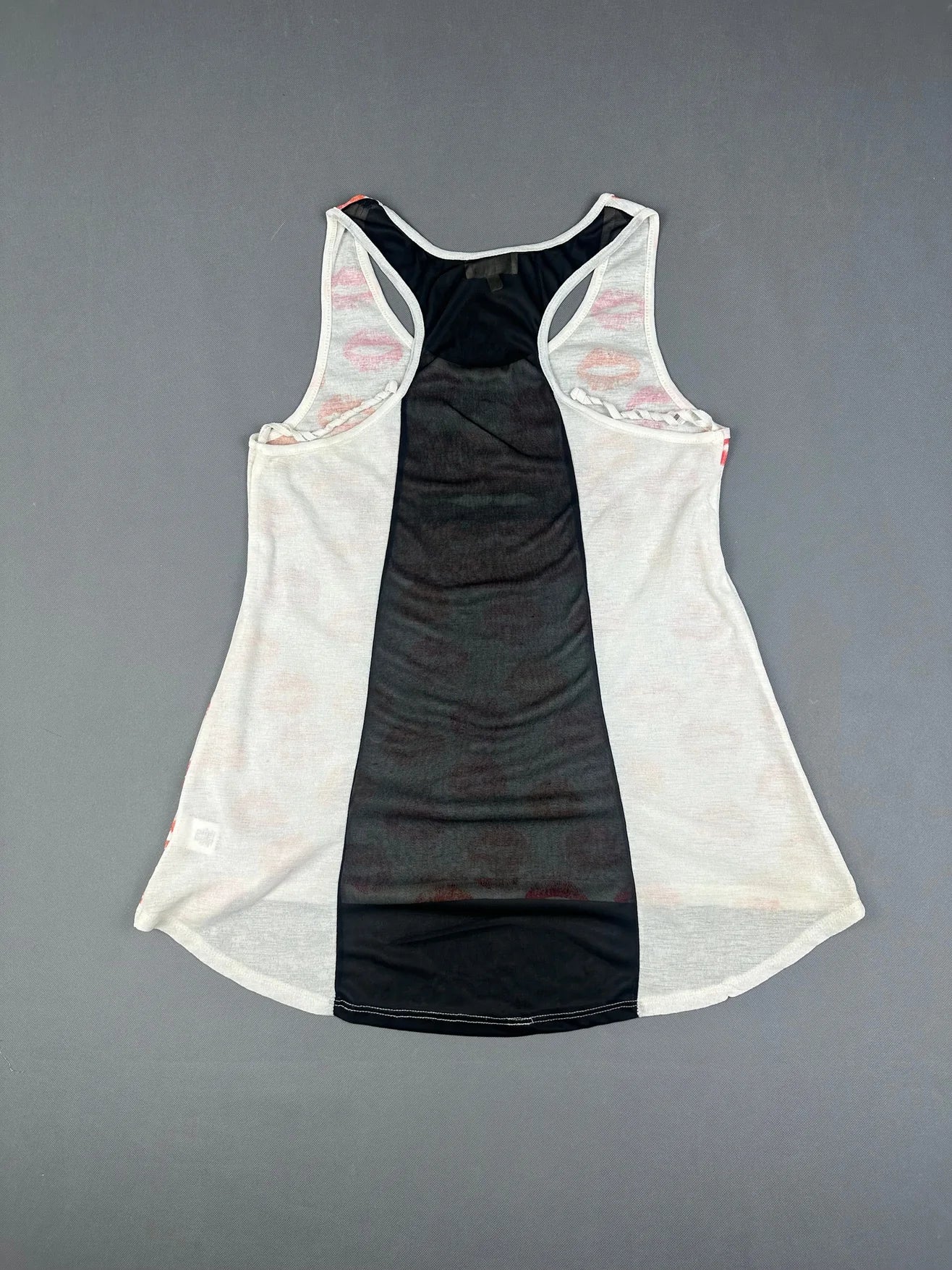 Back view of a tank top in white with a black center panel.