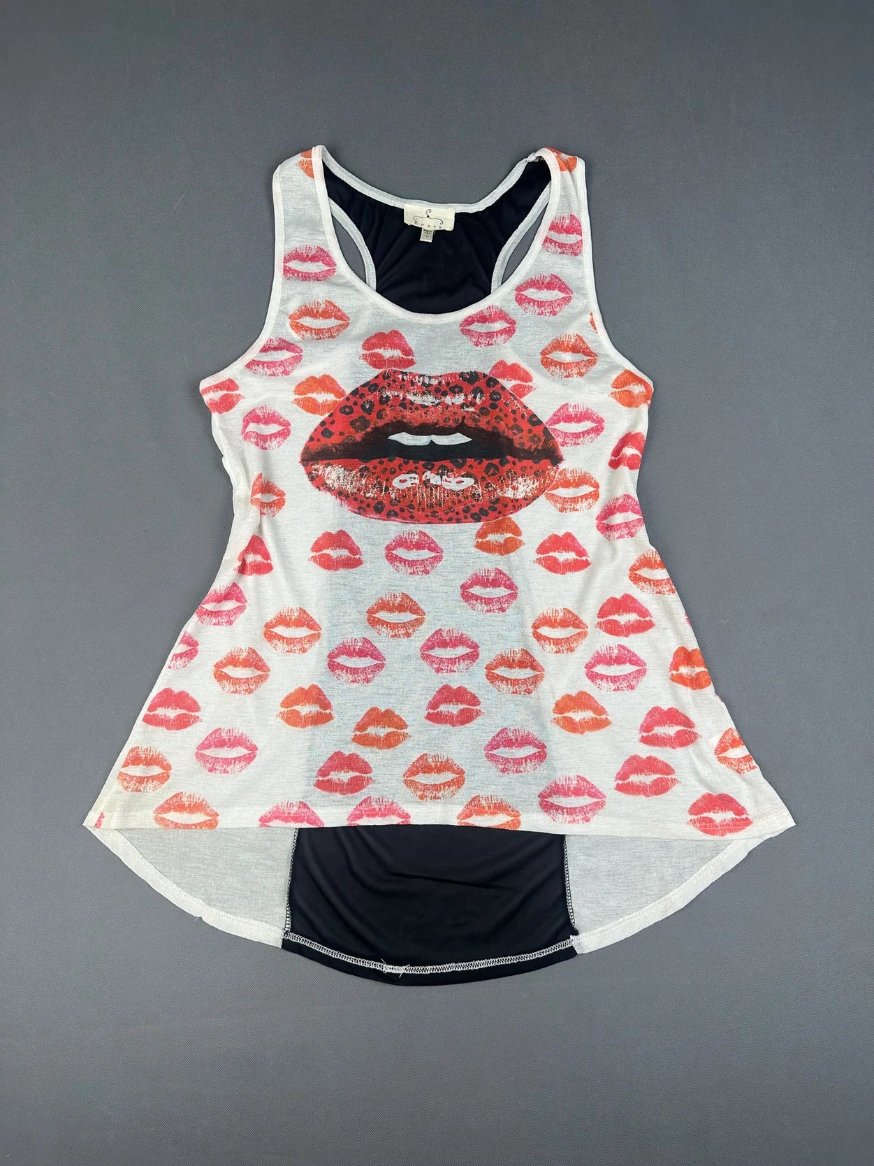 Front view of a tank top with colorful lip prints on a white background.