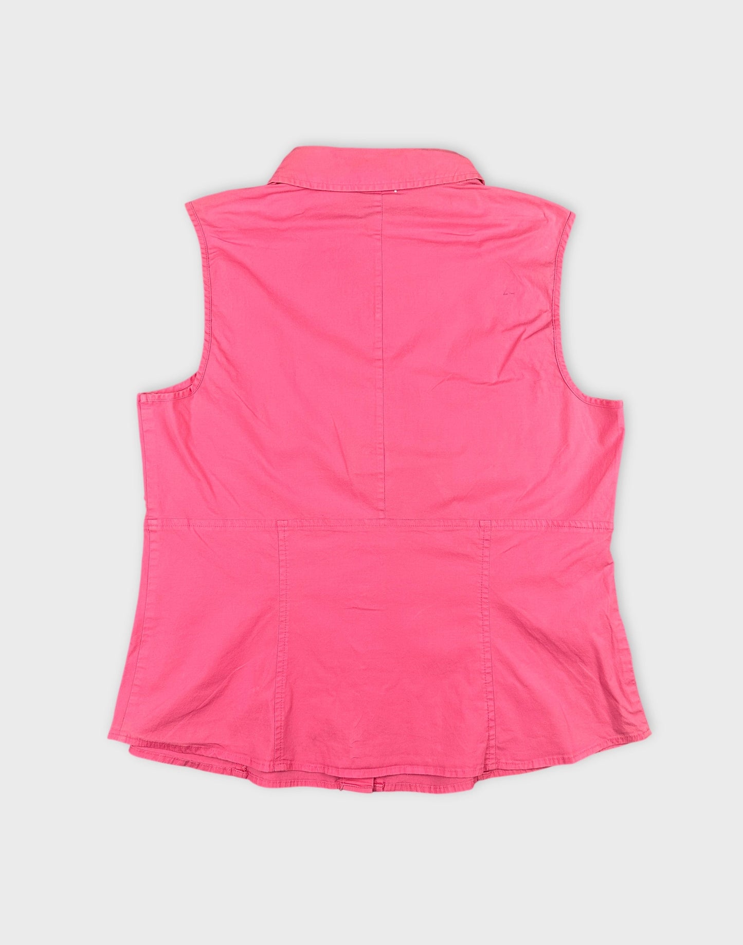Back view of a pink women’s button-up shirt with a collar.
