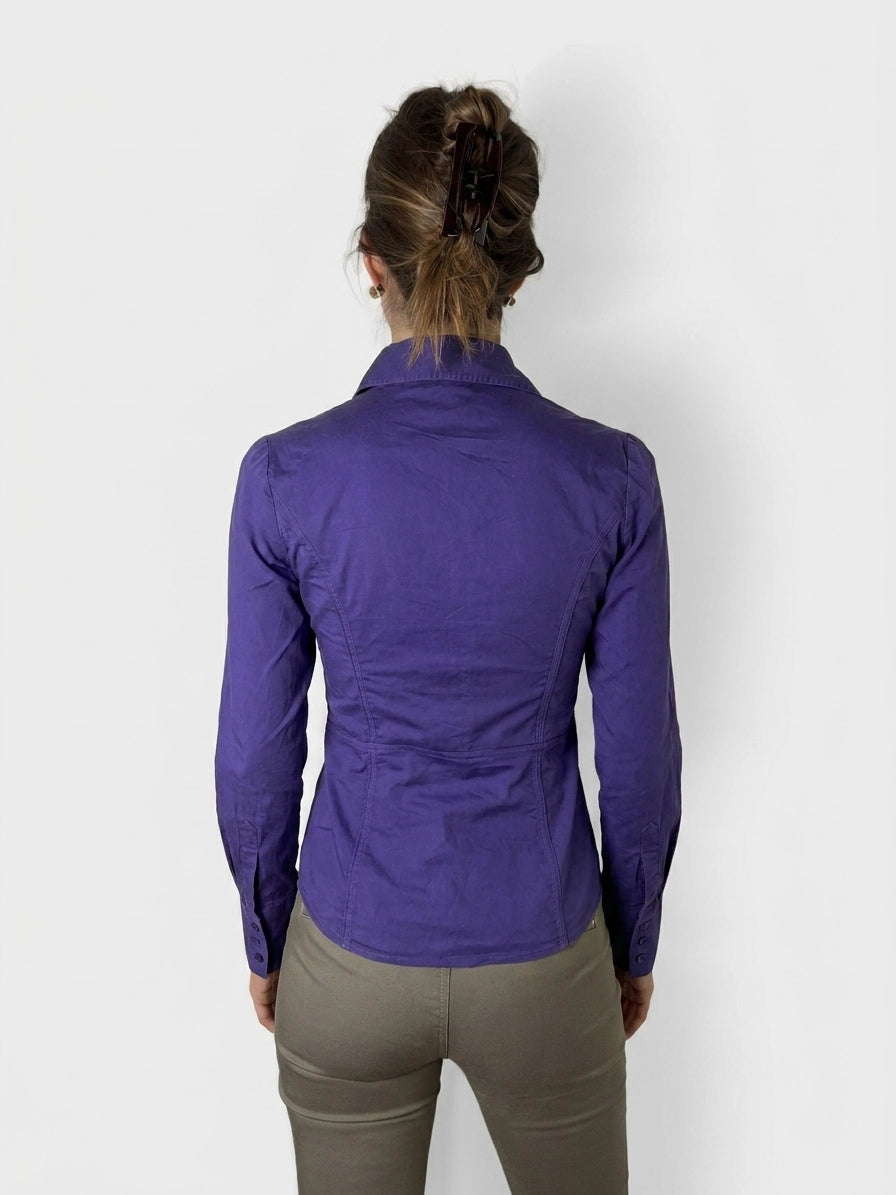 Back view of a purple button-up shirt featuring fitted shape and long sleeves.