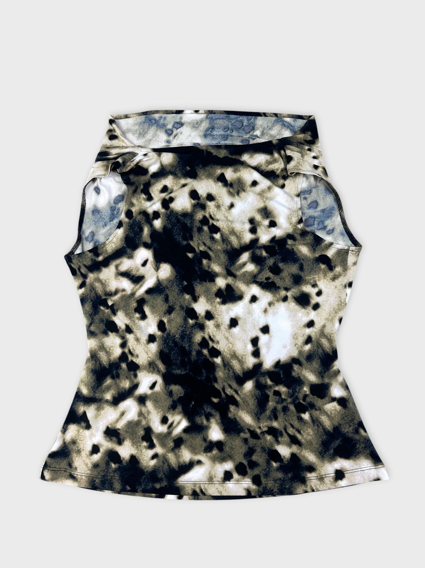 Back view of a short sleeve top in a black and cream abstract pattern