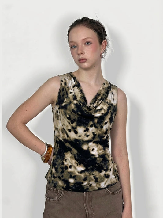 Front view of a short sleeve top in beige and black, featuring a draped neckline.