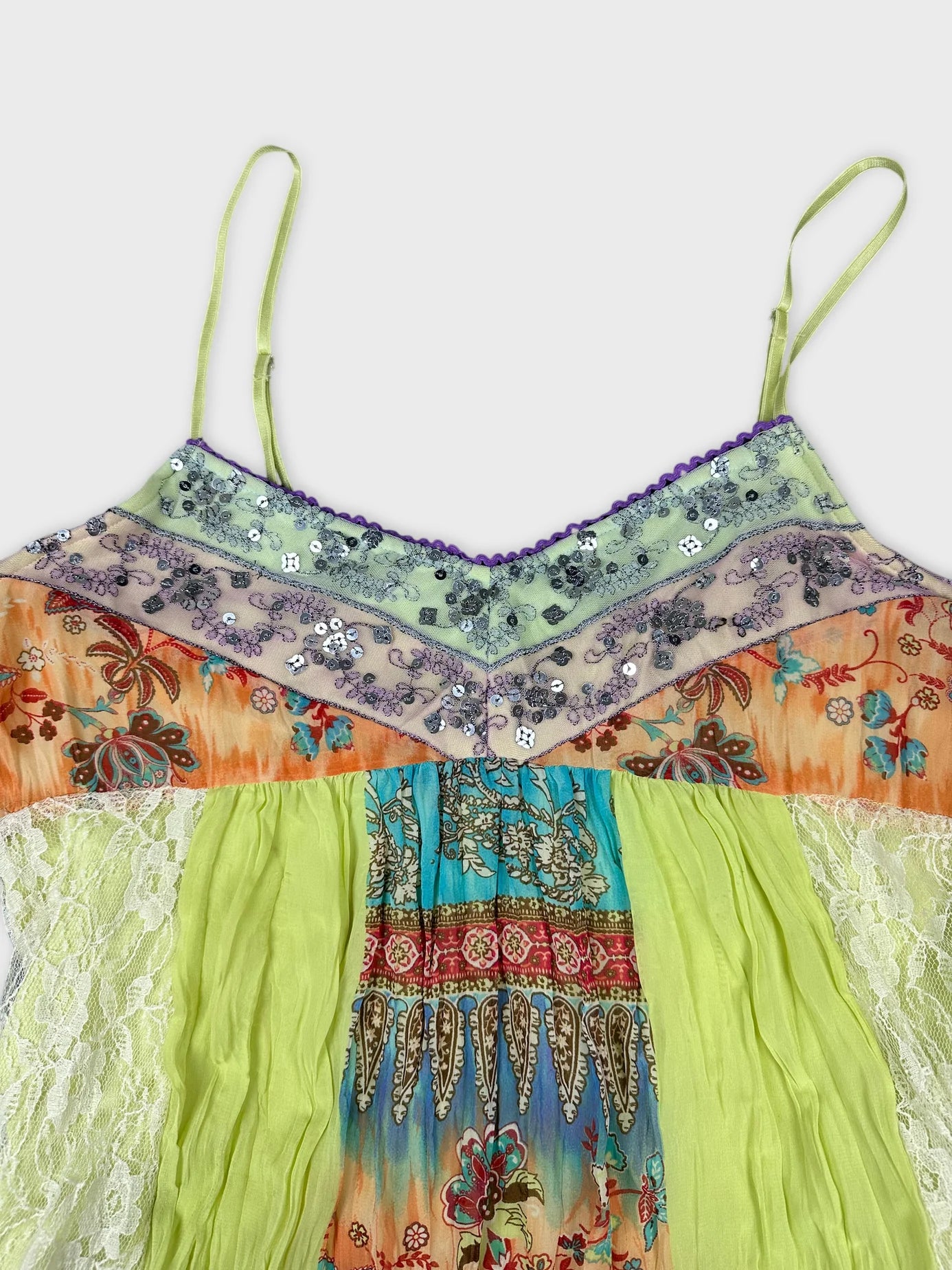 Detail view of a vintage upper body shorts with colorful floral print and lace detail.