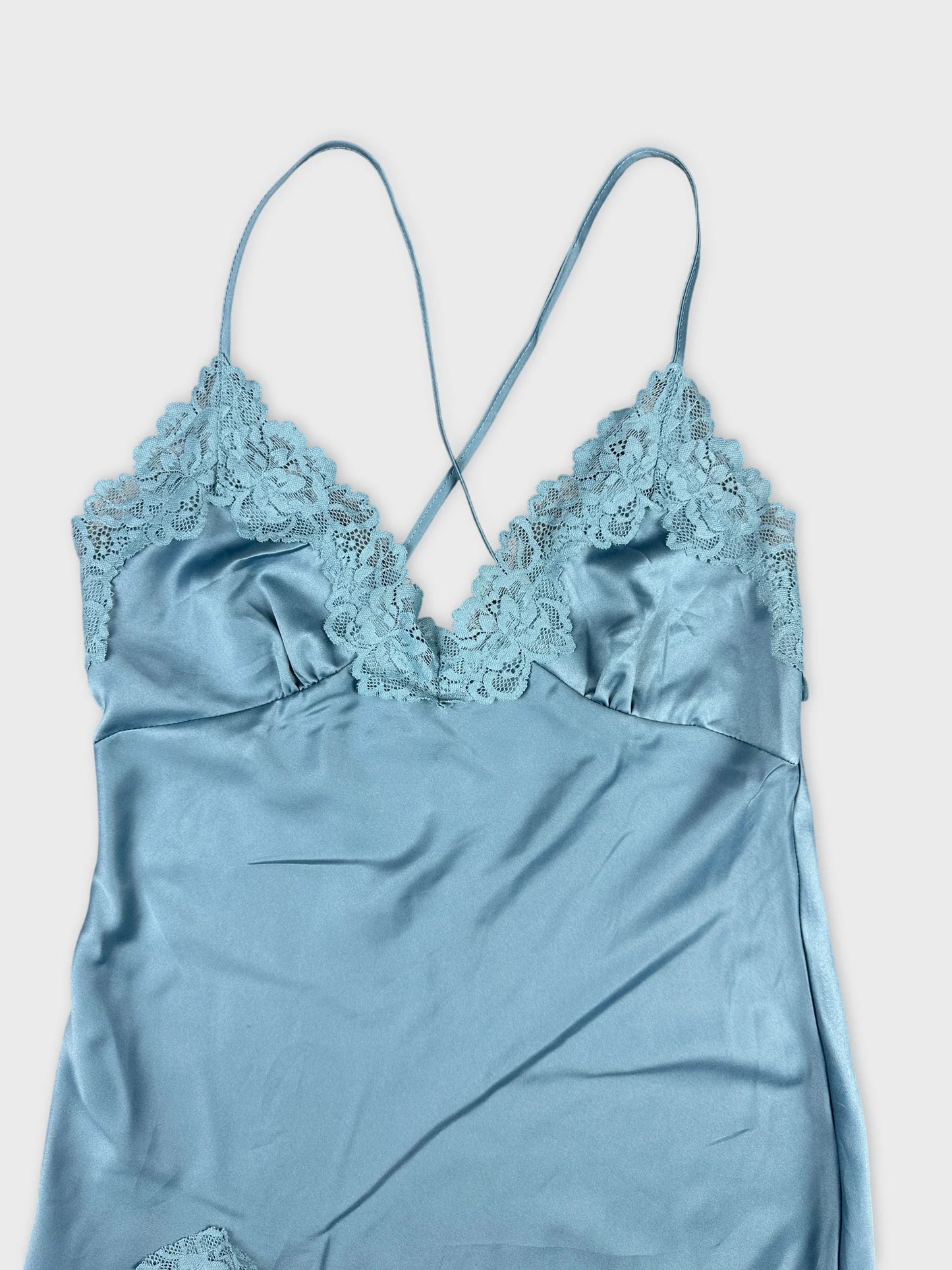 Detail view of a light blue camisole with lace trim.