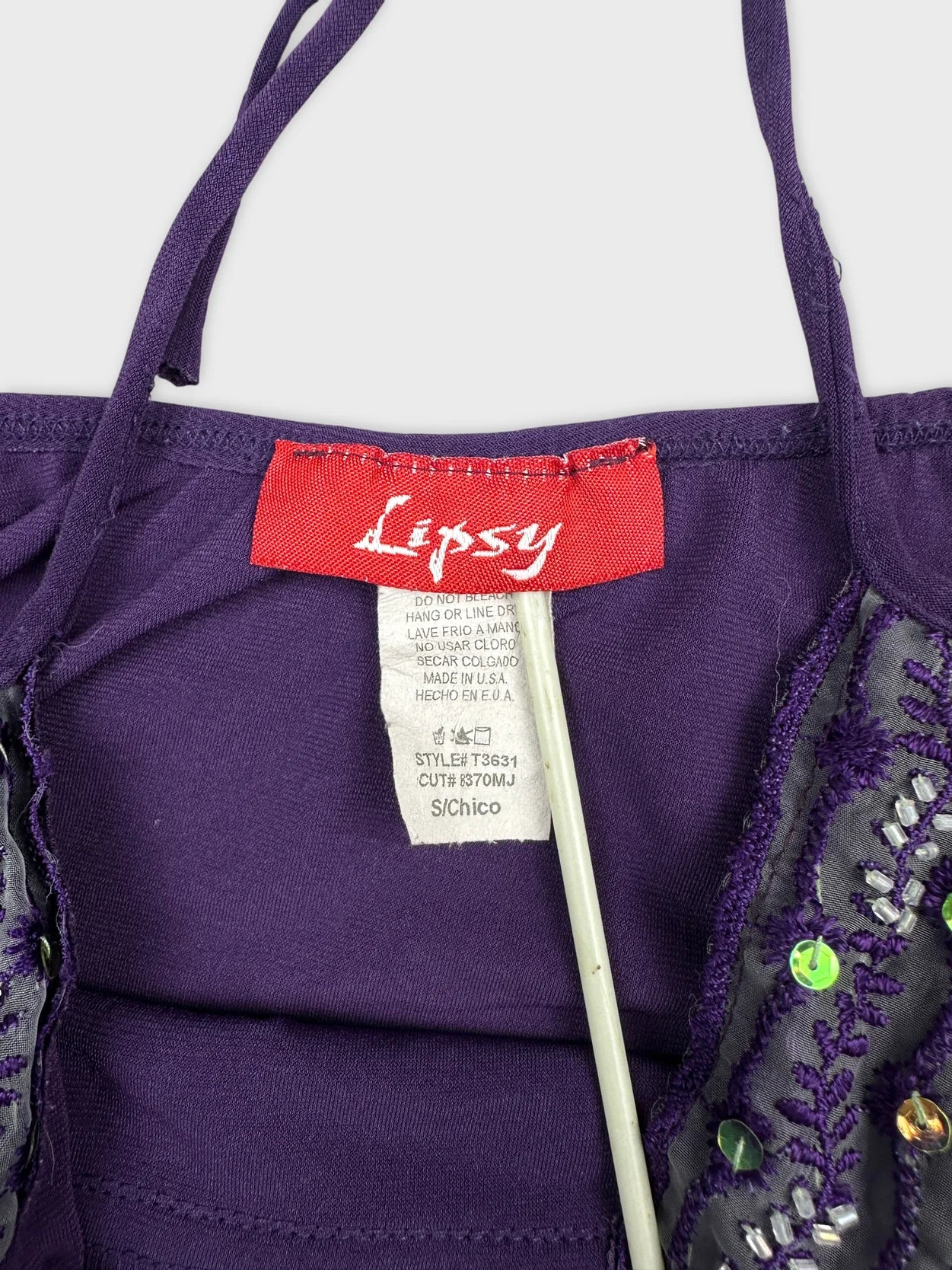 Detail view of purple upper body shorts featuring decorative embellishments.