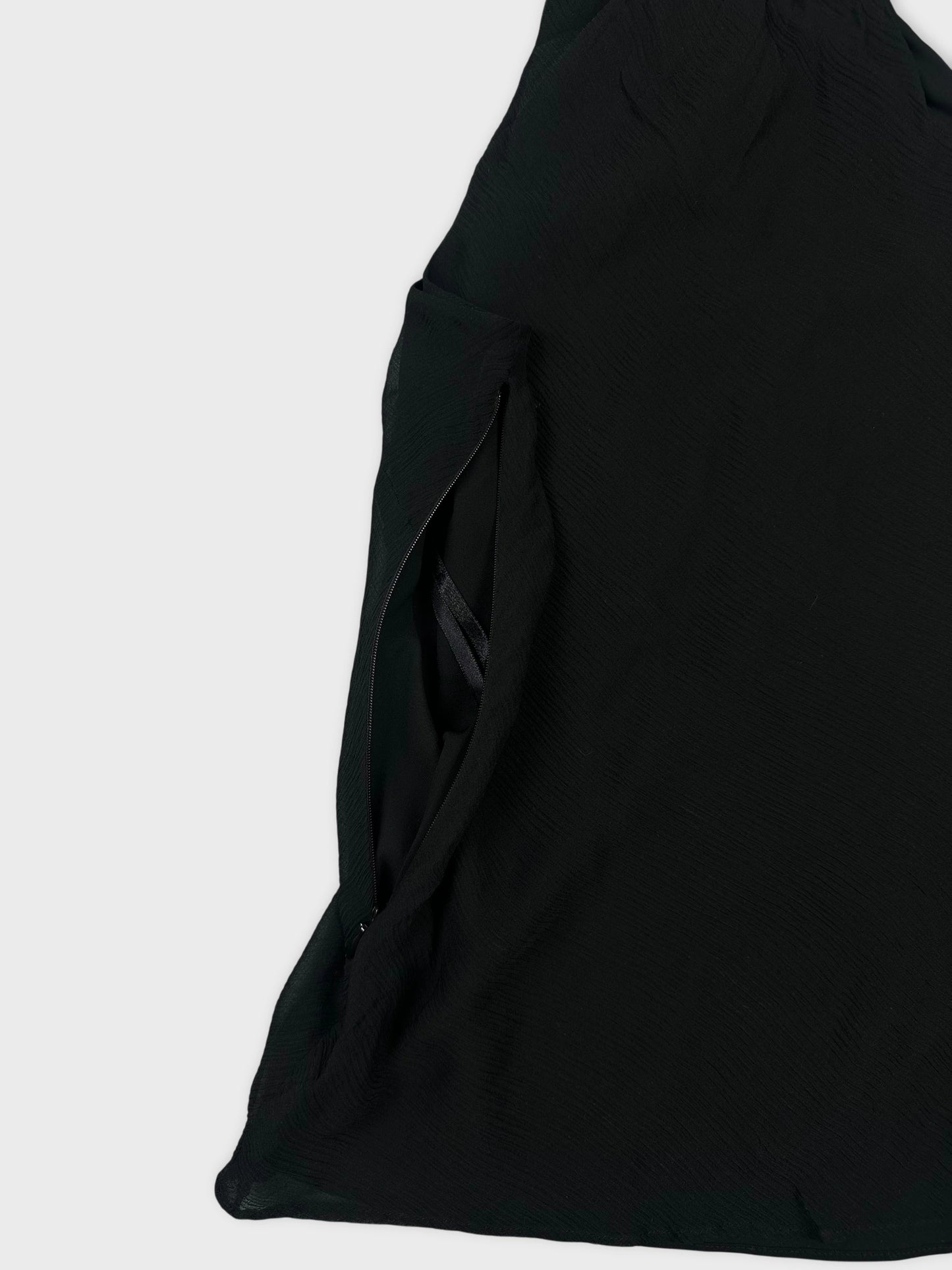 Detail view of black upper body shorts featuring a side zip.