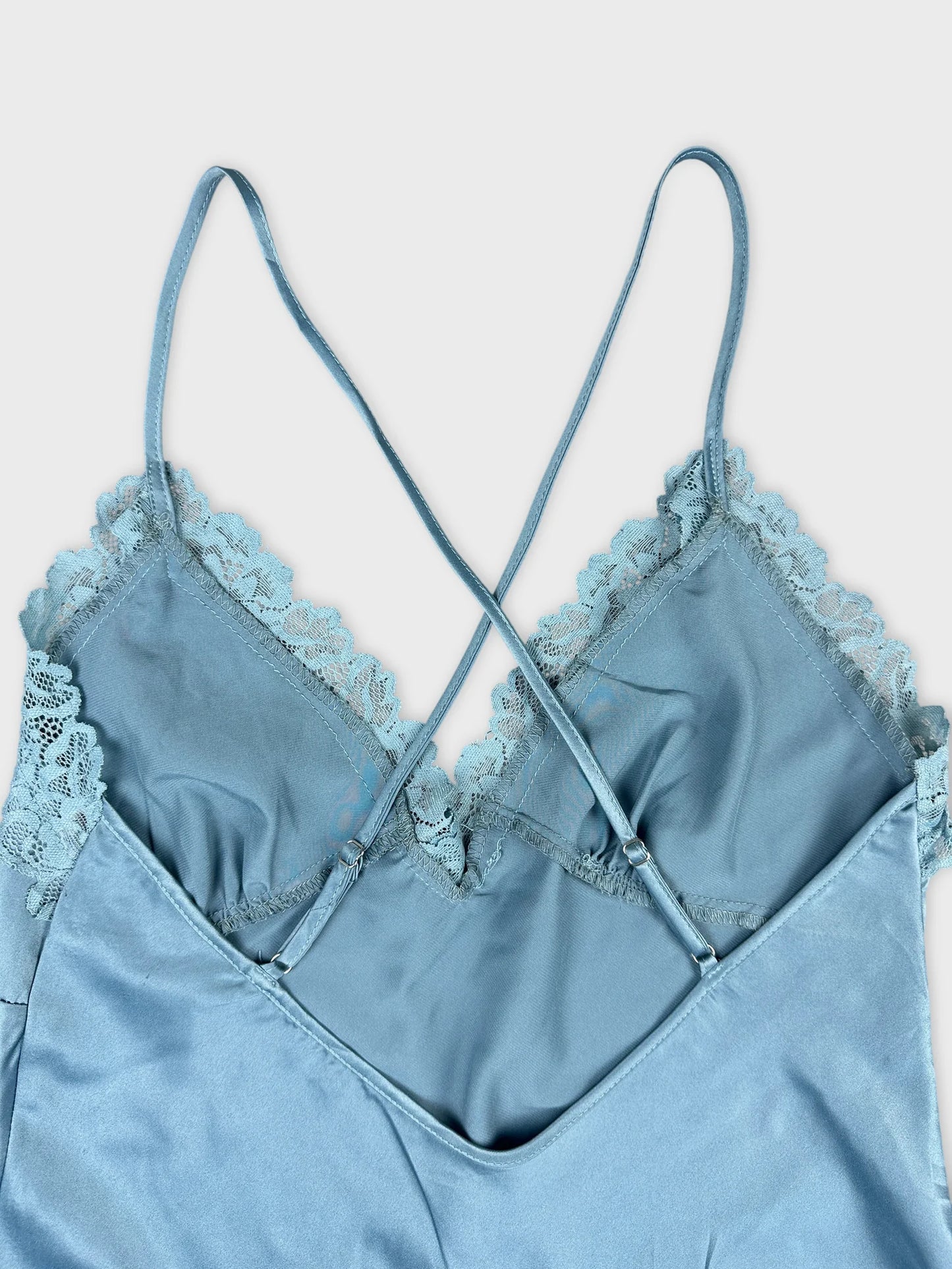 Detail view of a blue upper body short with lace trim.
