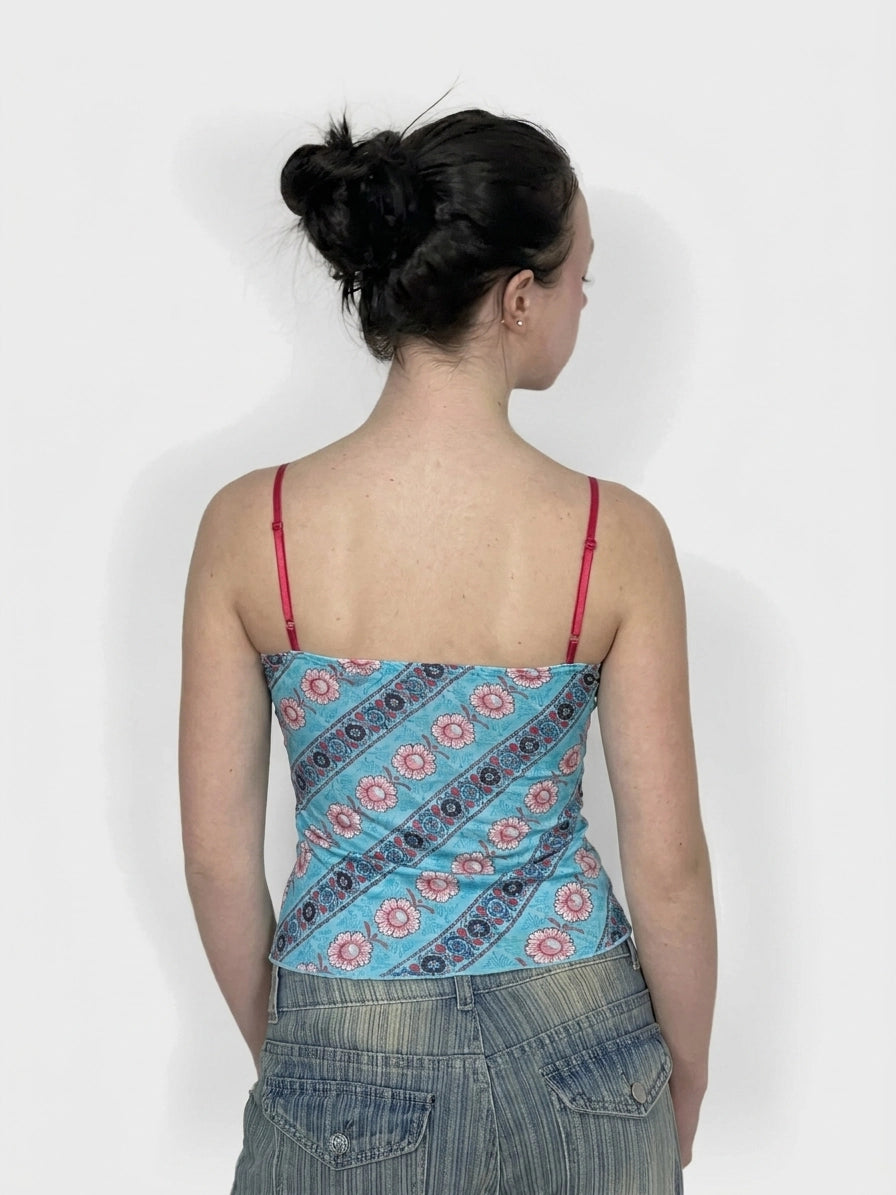 Back view of a blue women’s upper body top with floral print.