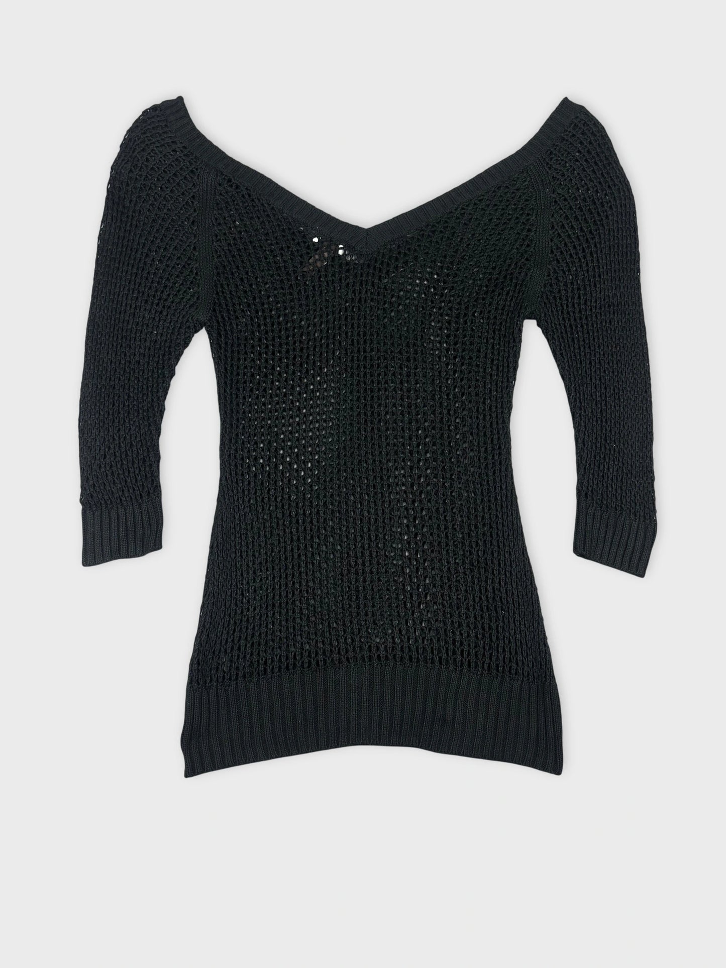 Back view of a black knit sweater with three-quarter sleeves.