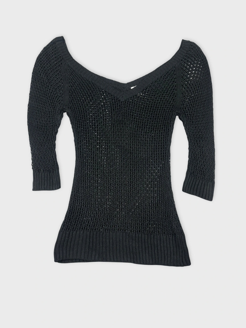 Black knit top with a v-neck and ribbed hem front view