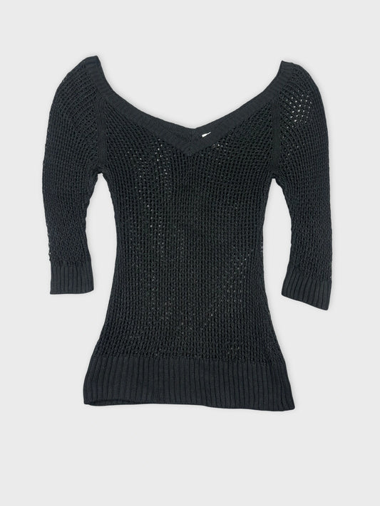 Black knit top with a v-neck and ribbed hem front view