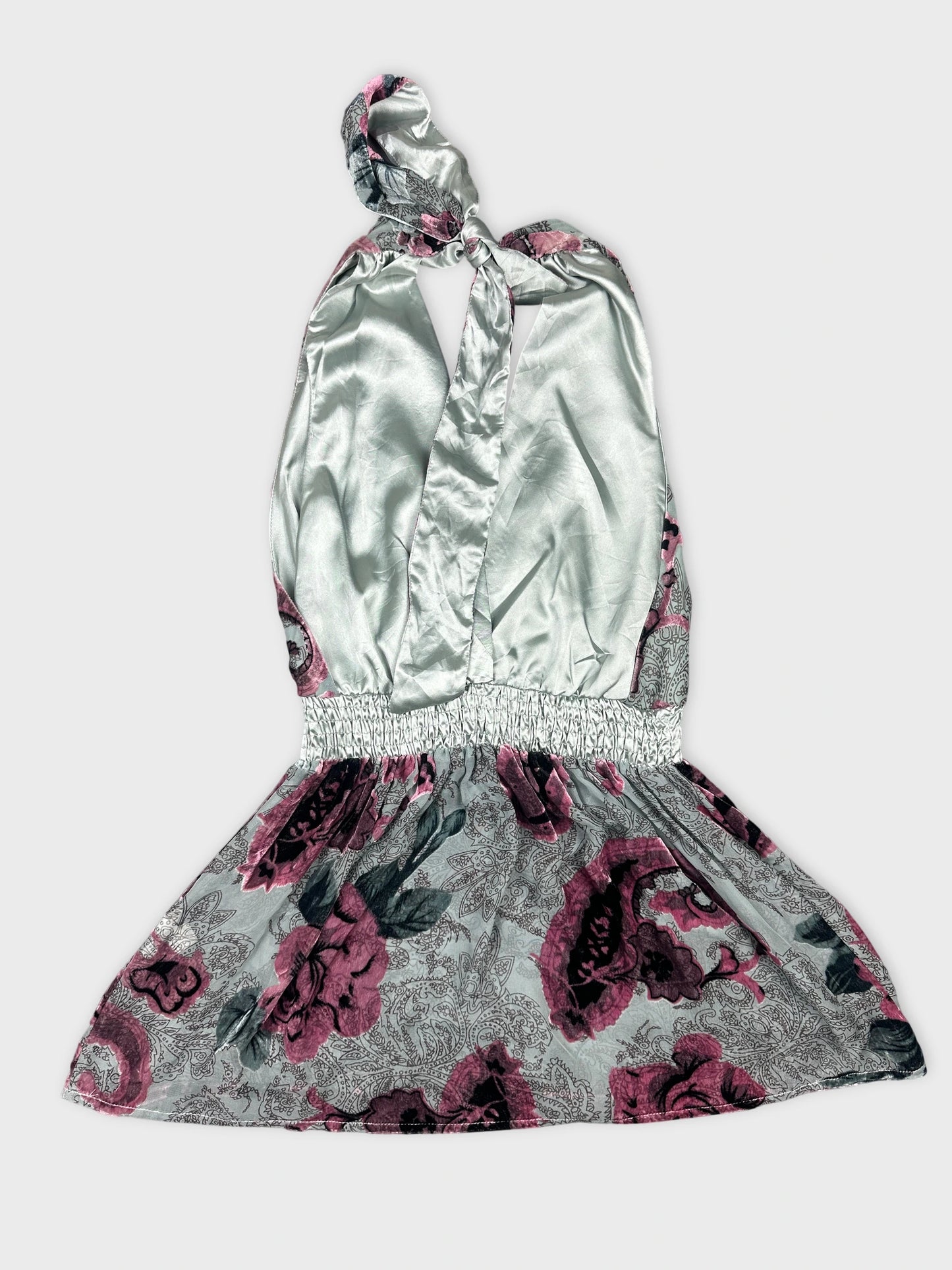 Back view of a vintage floral dress with a light gray base and purple roses.
