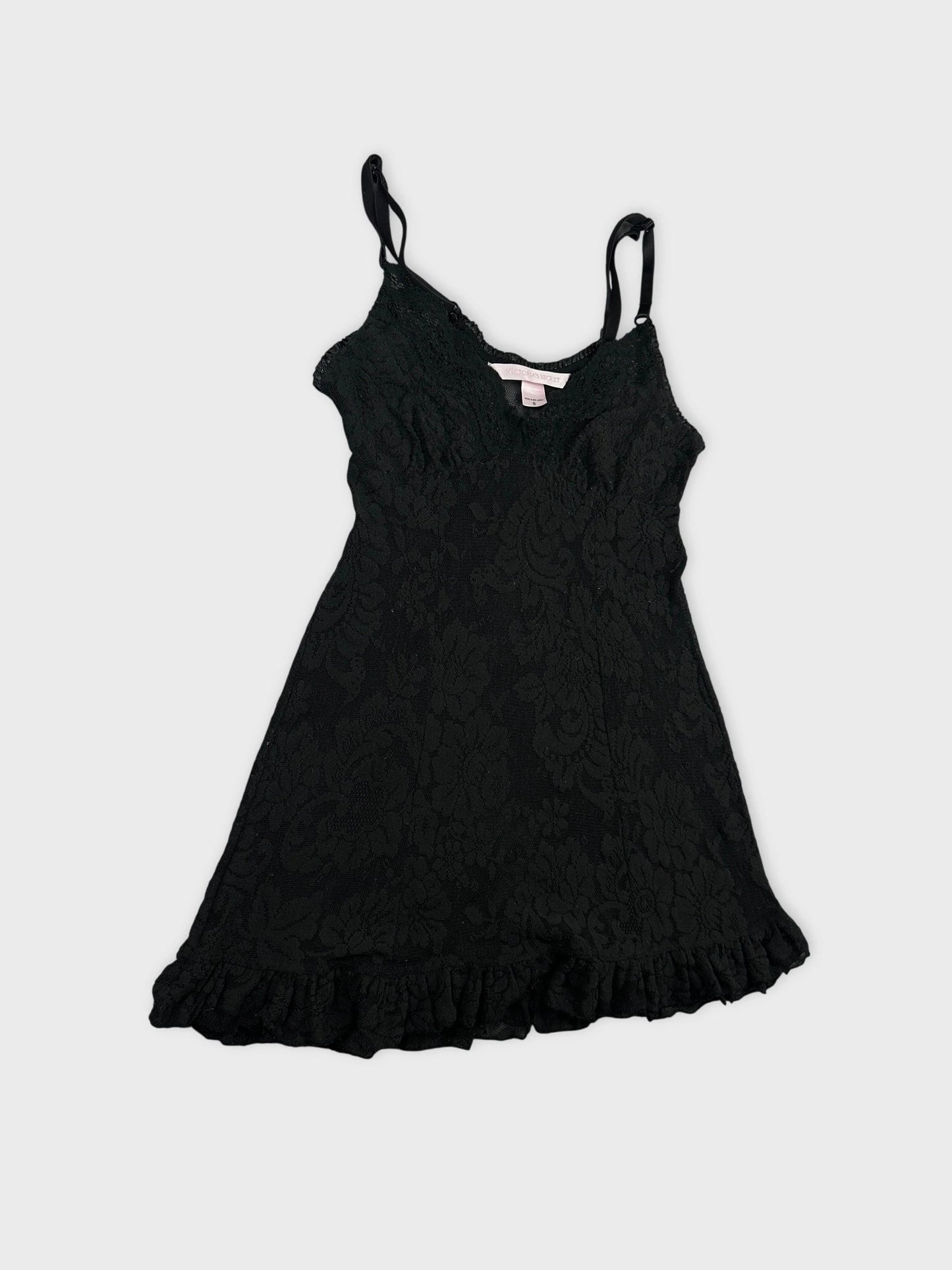 Detail view of a black lace-trimmed women's top with floral pattern.